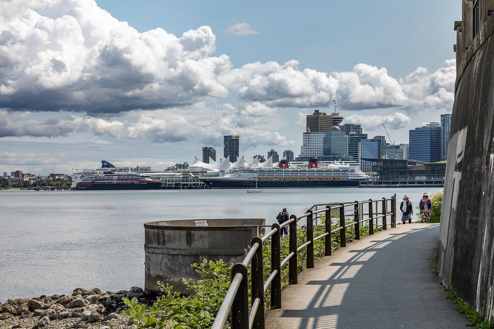 Cruise ships docked at Canada Place in Vancouver seen from the Stanley Park seawall, where an Alaska cruise from Vancouver begins