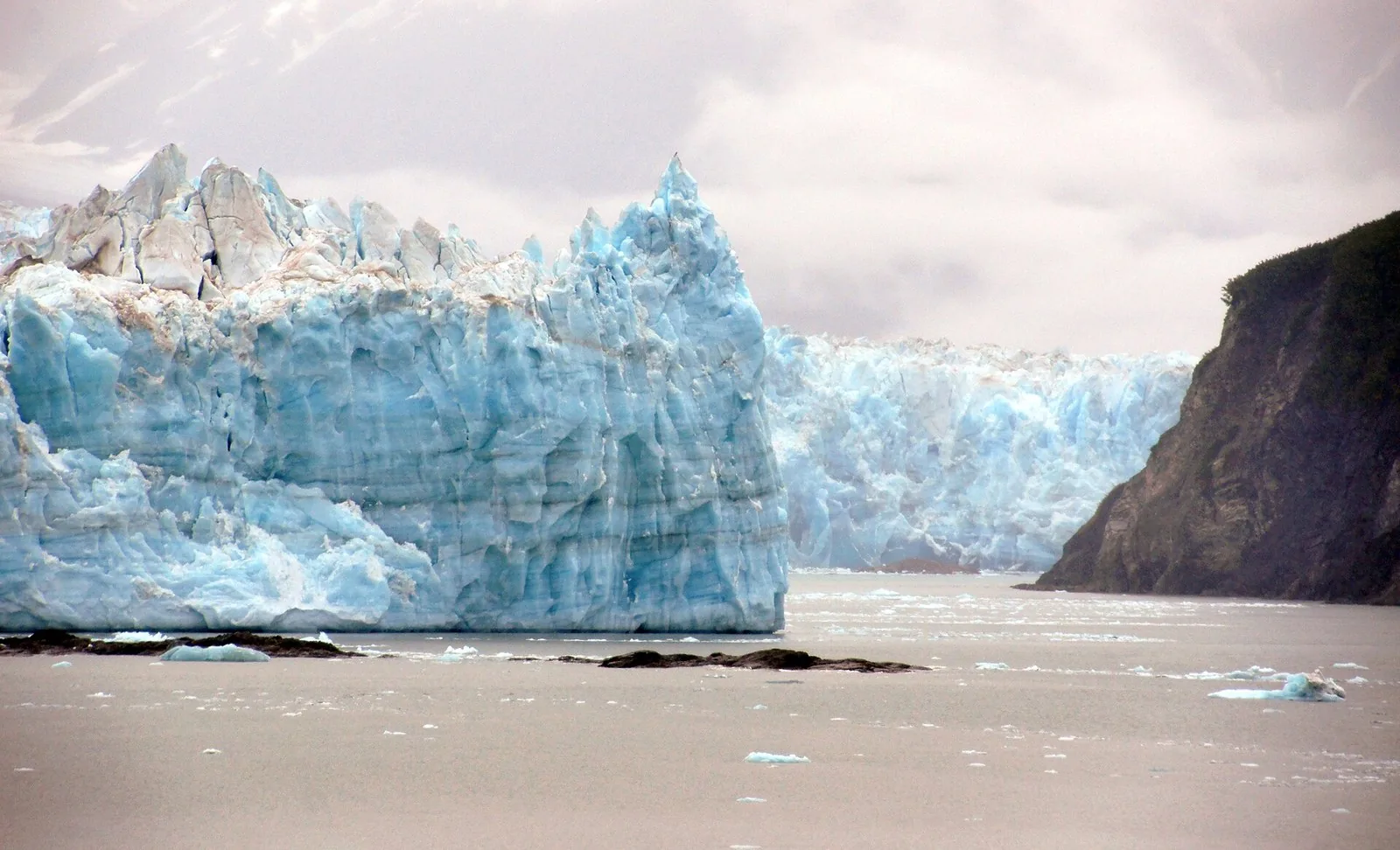 Towering blue ice at the face of Hubbard Glacier above Disenchantment Bay on an Alaska glacier cruise