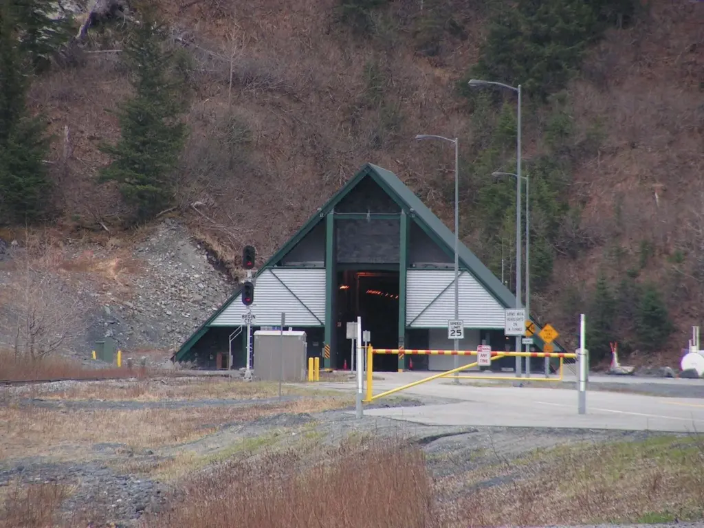 The concrete west portal of the Anton Anderson Memorial Tunnel with its gate arm and signals