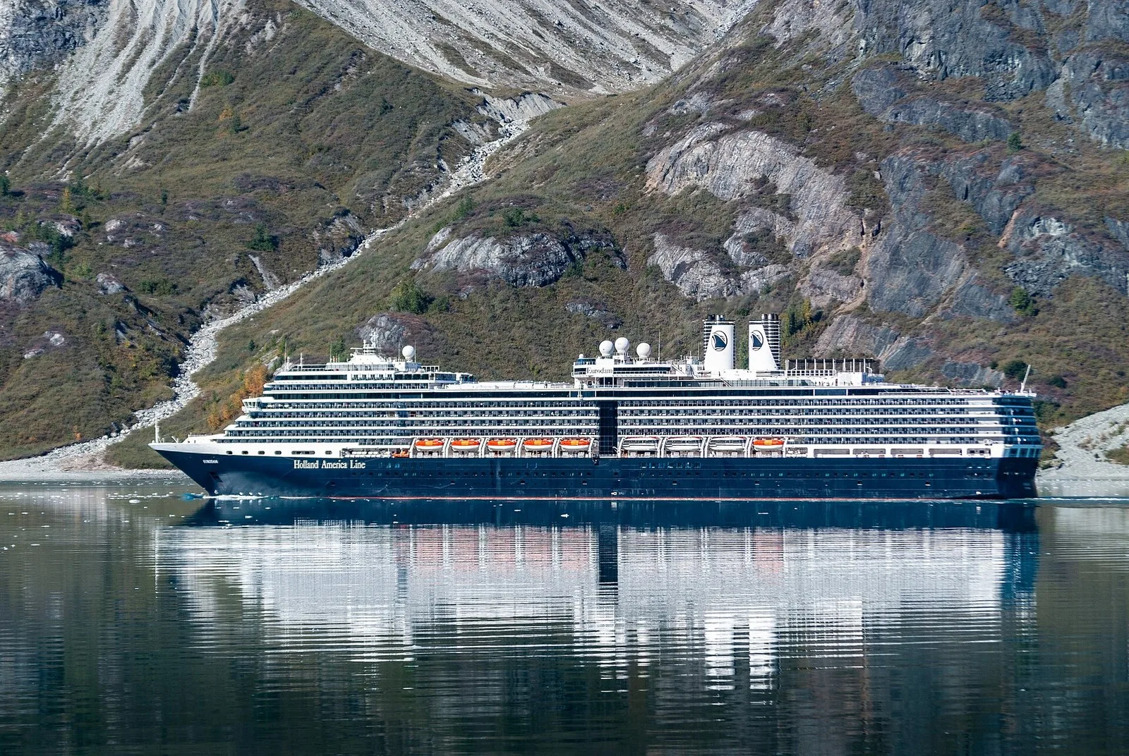 Holland America cruise ship Eurodam in calm water at the entrance to Reid Inlet in Glacier Bay National Park; Glacier Bay access is a big part of choosing the best cruise line for Alaska
