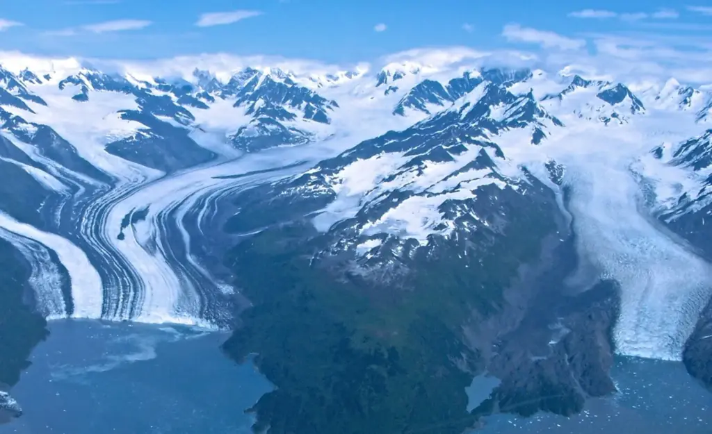Aerial view of Harvard Glacier and Yale Glacier flowing between mountains into the sea