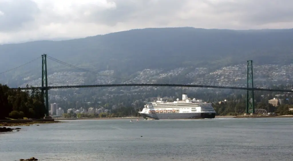 Cruise ship passing under the green Lions Gate Bridge on the way out of Vancouver Harbour
