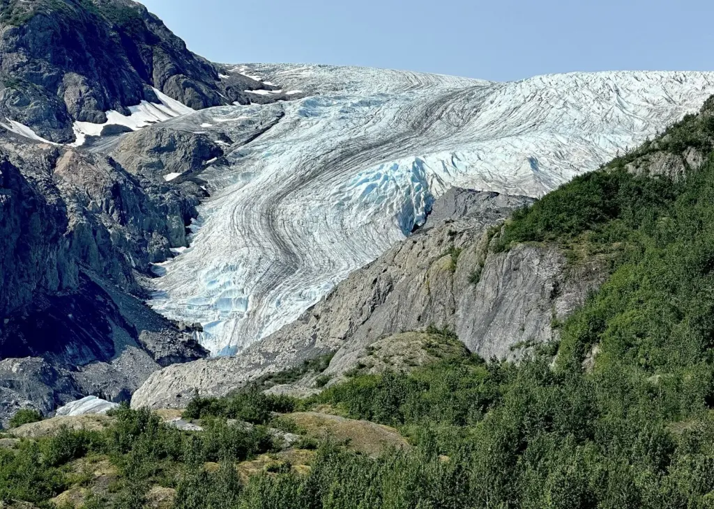 Exit Glacier's crevassed ice flowing down a rocky valley from the Harding Icefield