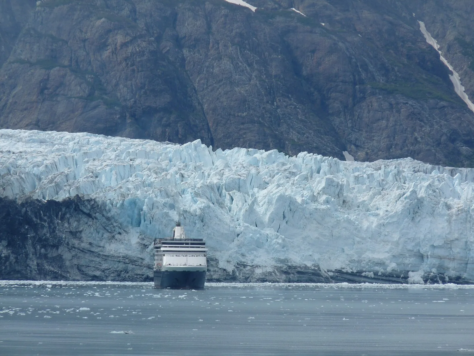 Cruise ship Statendam in front of a tidewater glacier face in Glacier Bay National Park