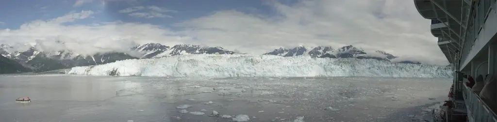 Panorama of the wide ice face of Hubbard Glacier across Disenchantment Bay seen from a cruise ship