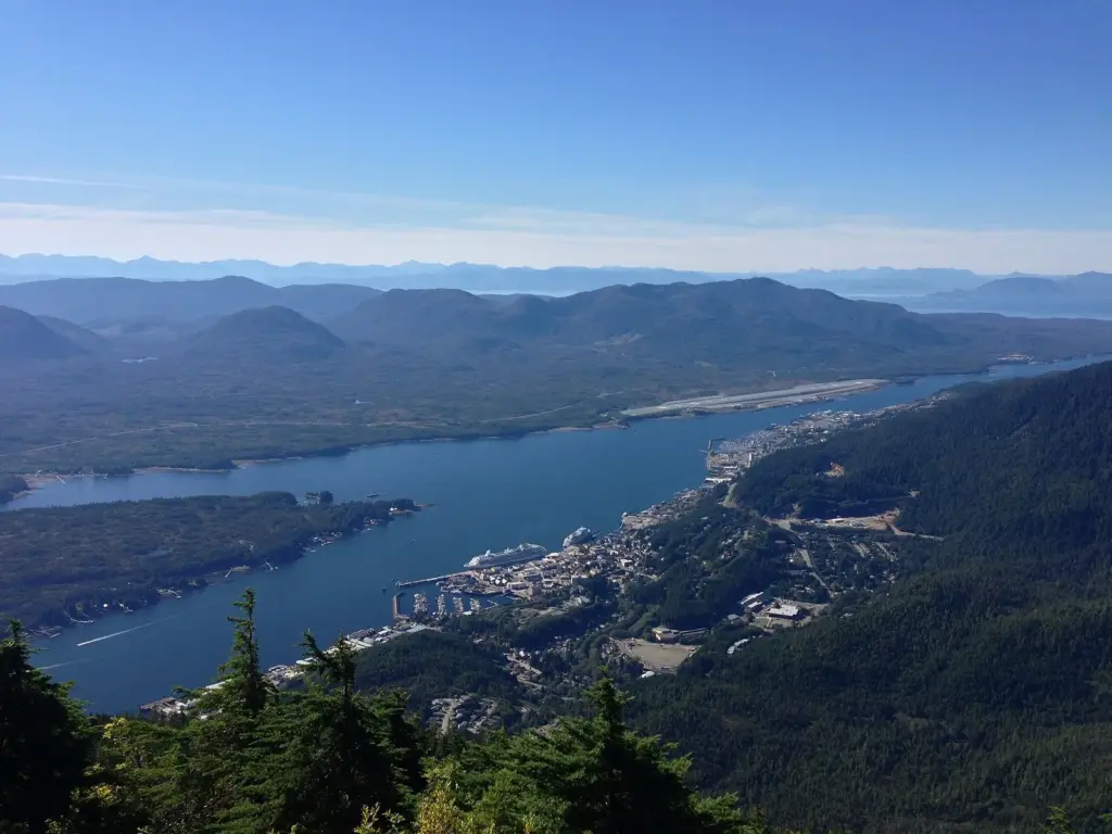 Ketchikan and the blue waters of Tongass Narrows seen from the summit of Deer Mountain, with islands and mountains beyond