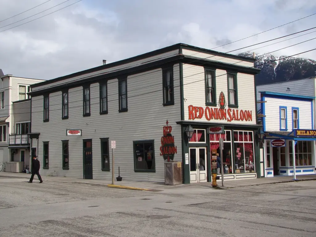 The two-story Red Onion Saloon on a corner of Broadway in Skagway, with its red painted sign and period storefront