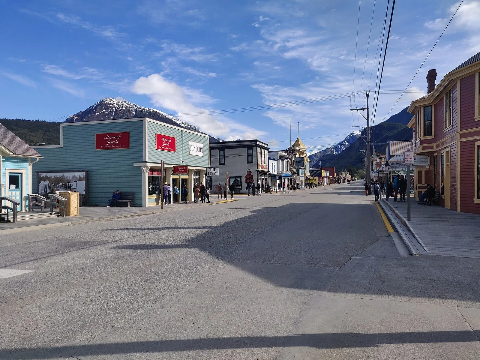 Historic false-front buildings along Broadway in Skagway under a blue sky with snowy mountains behind, the heart of most things to do in Skagway