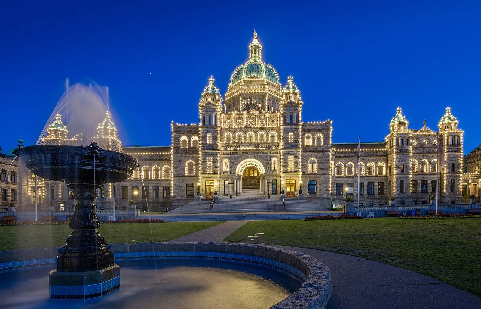 British Columbia Parliament Buildings outlined in lights at dusk, a highlight of an evening at the Victoria BC cruise port